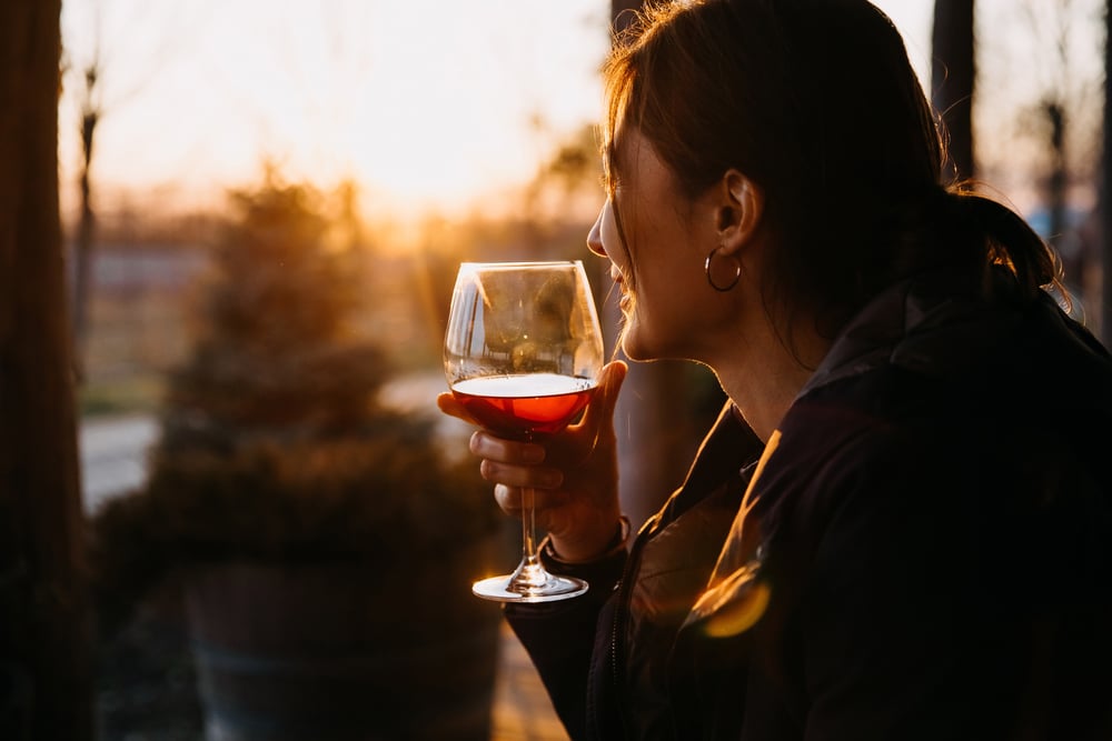 Woman enjoying a glass of wine at a tasting room like Orcas Island Winery
